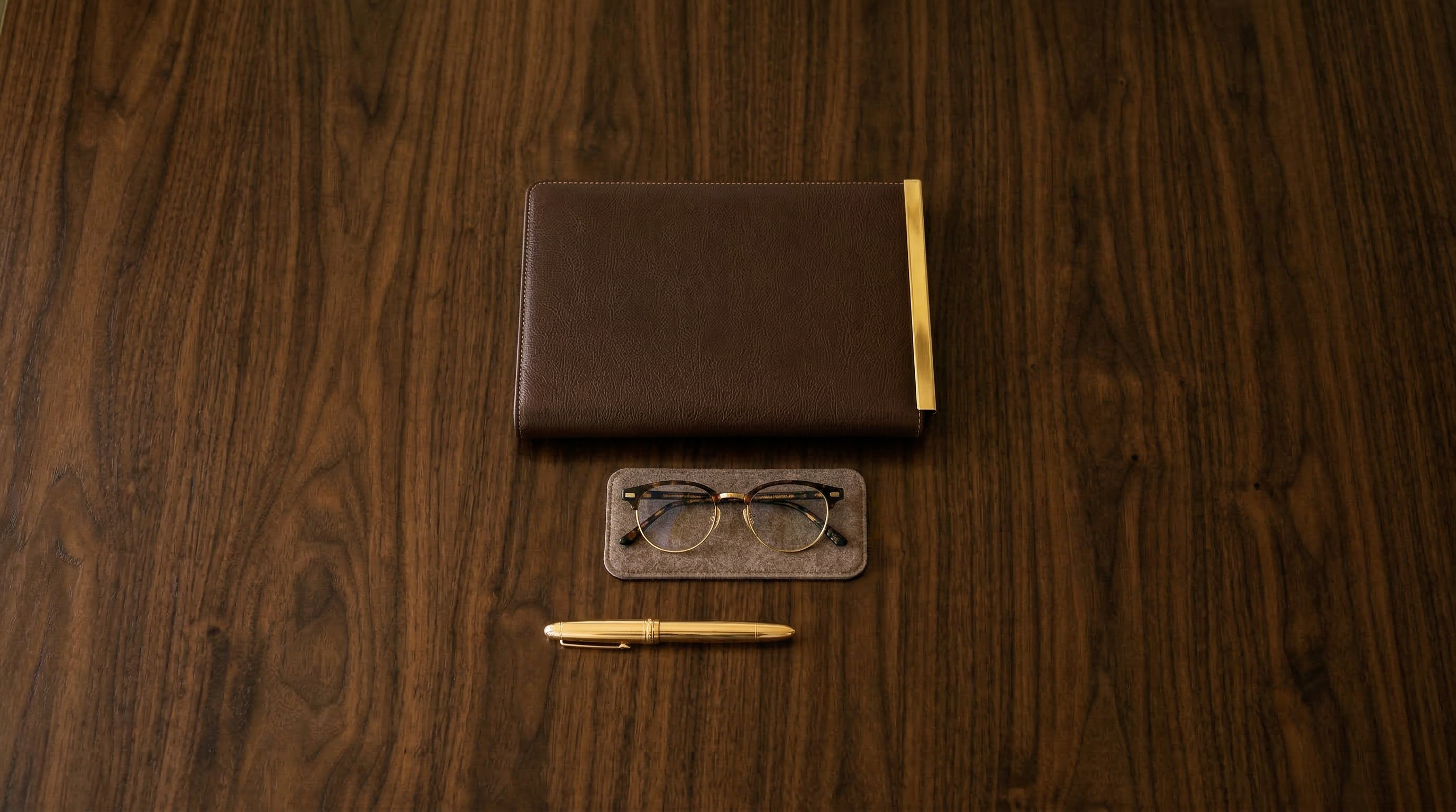 Professional desk with leather portfolio and gold pen